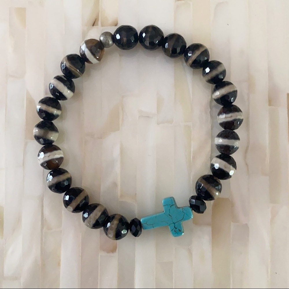 Turquoise and black beaded cross bracelet.